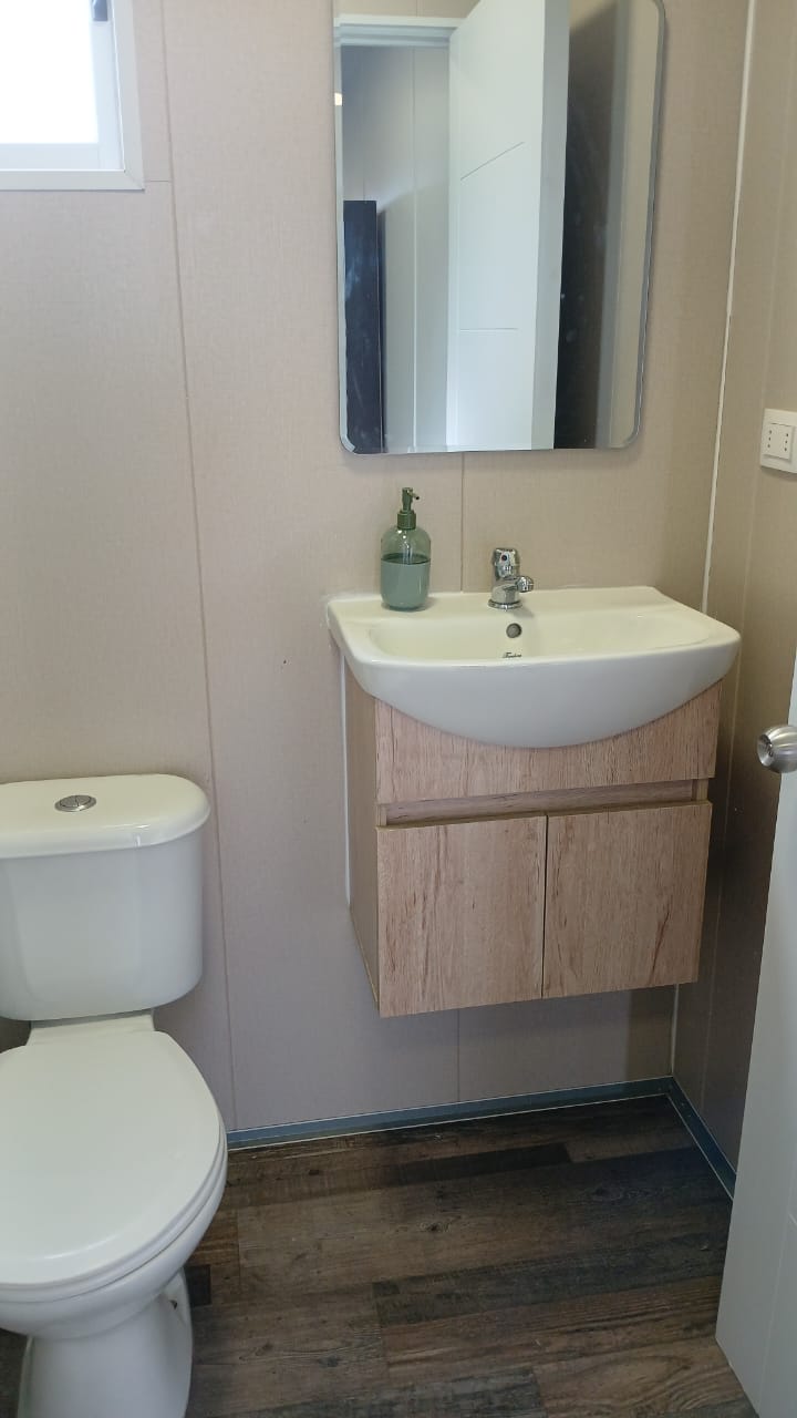Baño privado: lavamanos con mueble y espejo